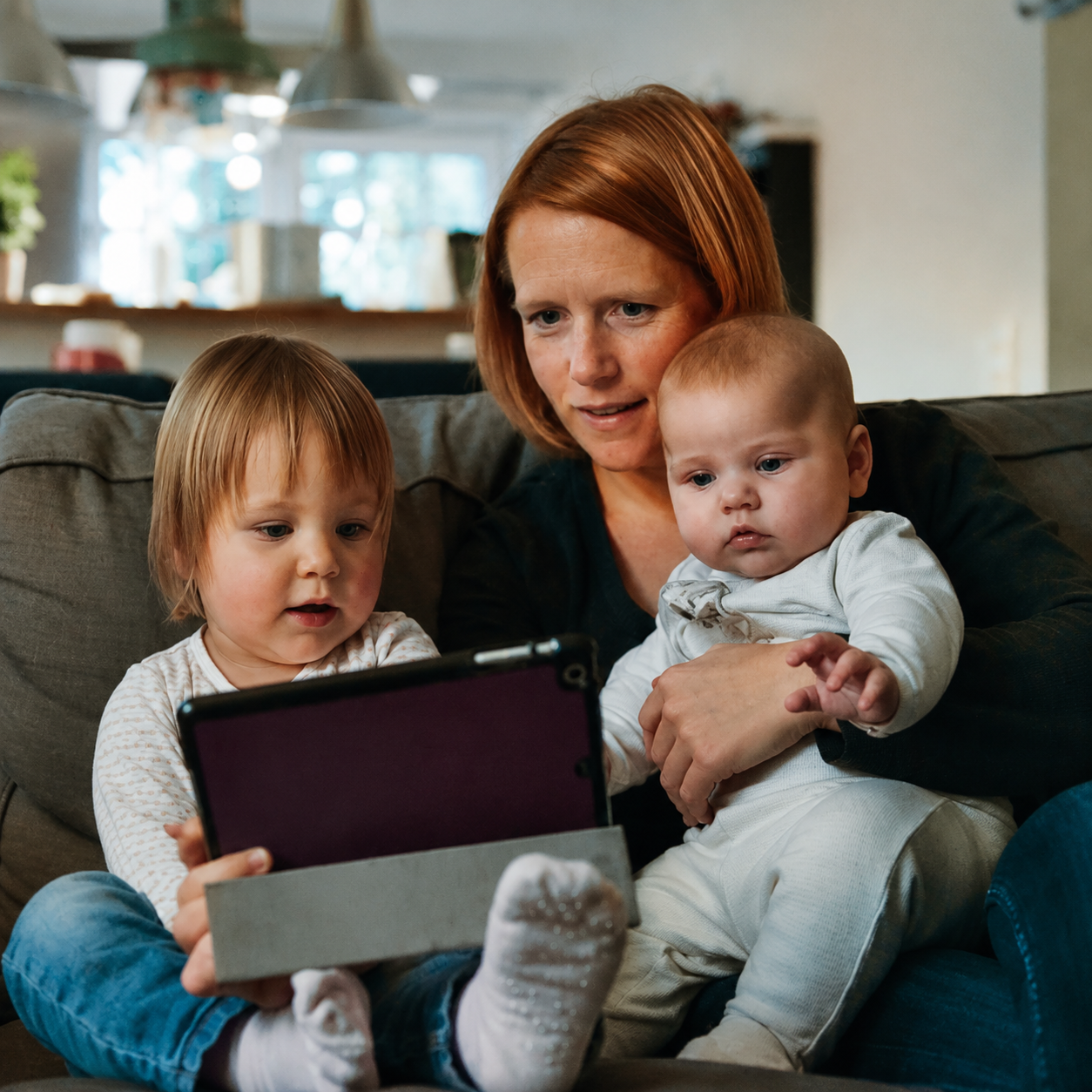 A family using a tablet together at home